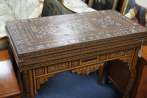 A 19th century Damascus mother of pearl, bone, and marquetry inlaid folding games table, with card, backgammon and chess surfaces, width 94cm, depth 47cm, height 85cm